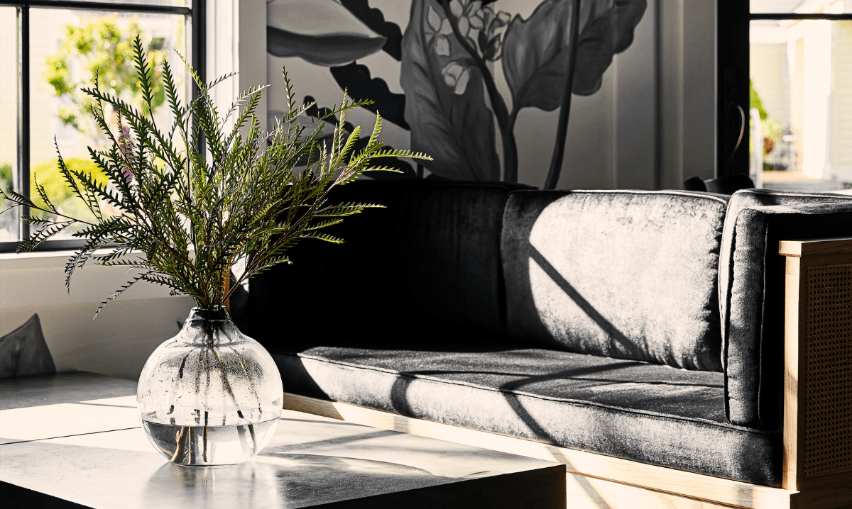 Black couch with flower vase