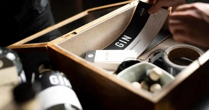 A person opening a box with a black and white