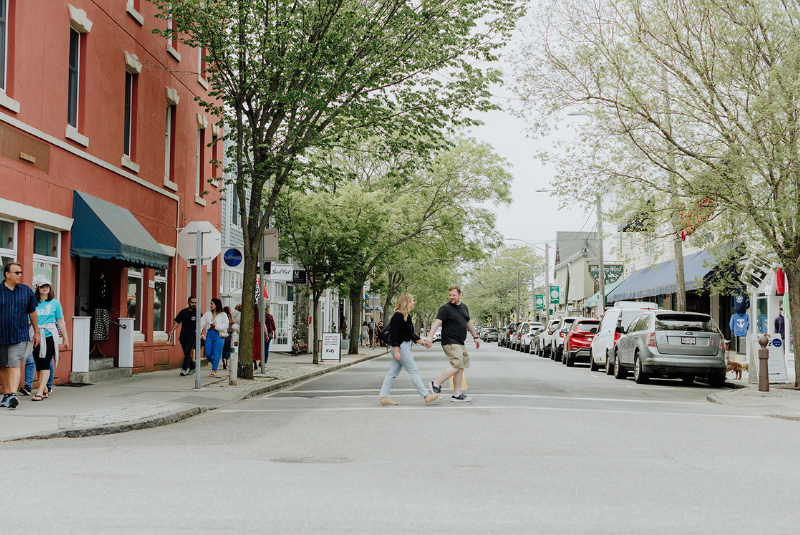 People holding hands walking in a road