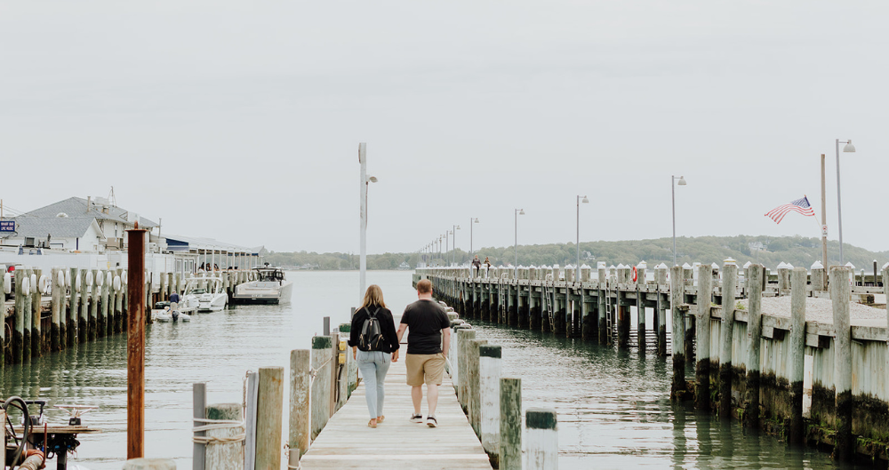 People holding hands on a dock