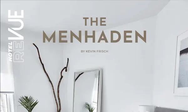 A white room with a mirror, plant, and picture on the wall, featuring the text