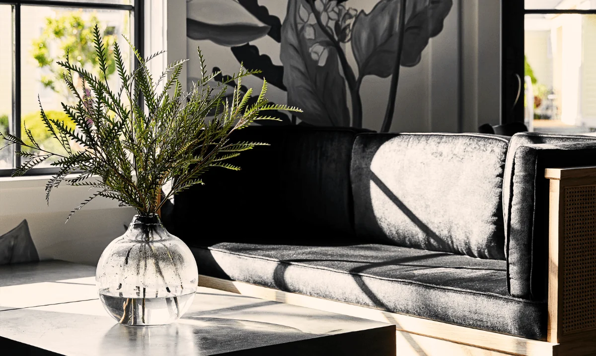 Black couch with flower vase